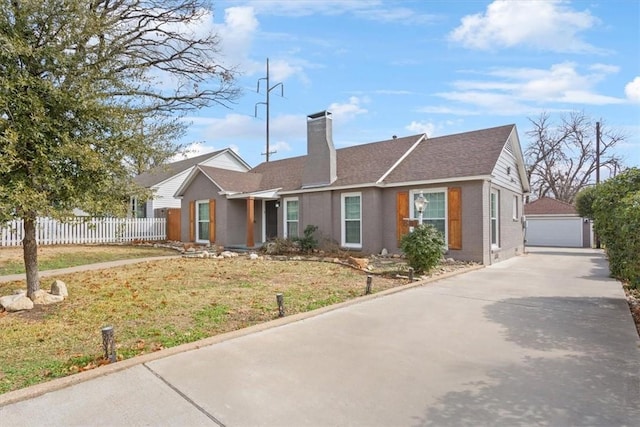 ranch-style house with an outbuilding, a garage, and a front yard