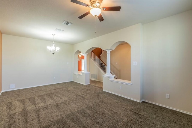 carpeted empty room featuring decorative columns and ceiling fan with notable chandelier