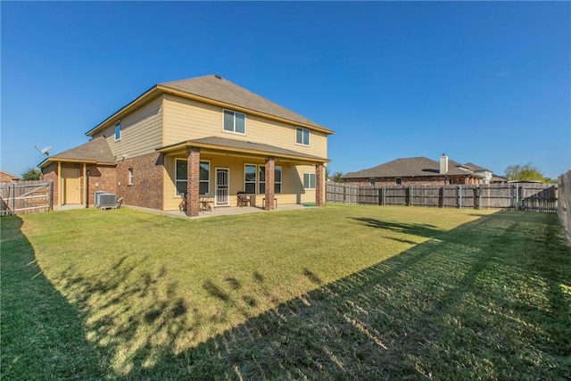 rear view of house featuring a patio, central air condition unit, and a lawn