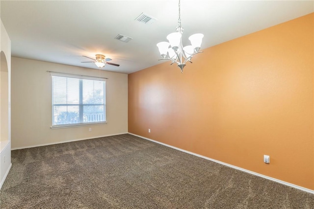 unfurnished room with dark colored carpet and ceiling fan with notable chandelier