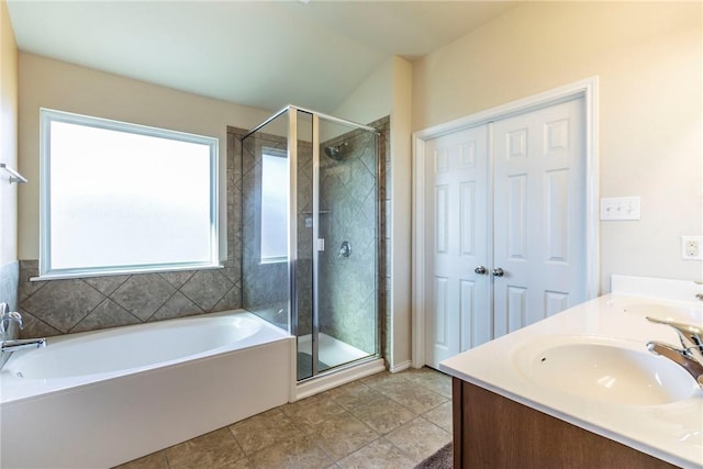 bathroom with plus walk in shower, vanity, and tile patterned flooring