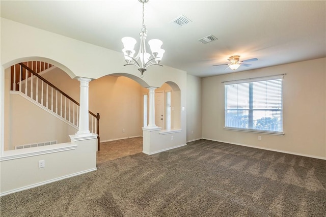 empty room featuring ceiling fan with notable chandelier and dark carpet