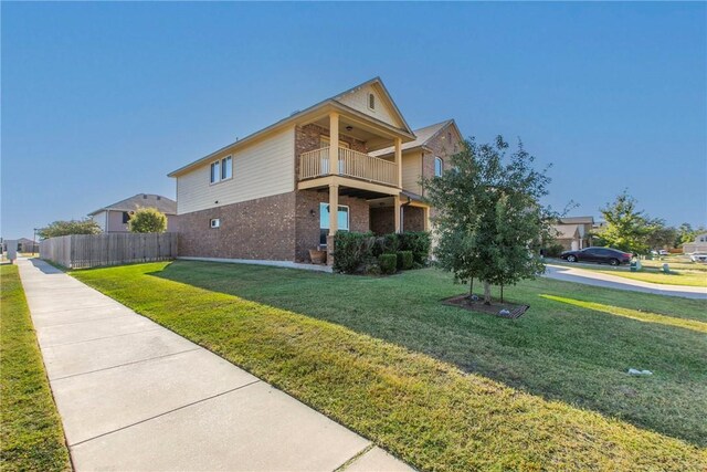 view of home's exterior featuring a yard and a balcony