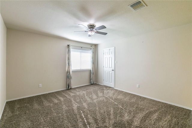 carpeted spare room with a textured ceiling and ceiling fan