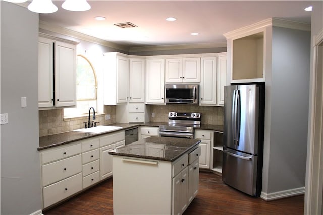 kitchen with white cabinets, a center island, and stainless steel appliances