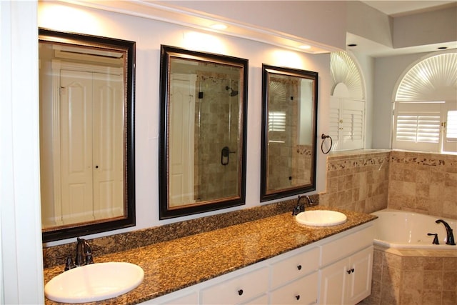 bathroom featuring vanity and plus walk in shower