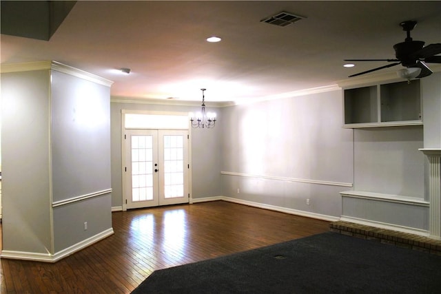 spare room featuring dark hardwood / wood-style flooring, french doors, ceiling fan with notable chandelier, and ornamental molding