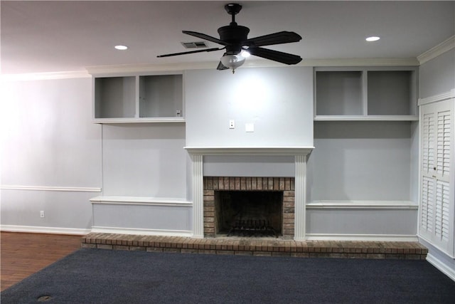 unfurnished living room with crown molding, a fireplace, ceiling fan, and wood-type flooring