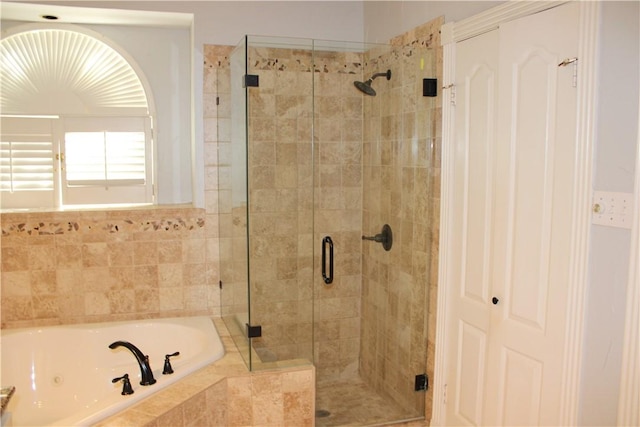 bathroom featuring independent shower and bath