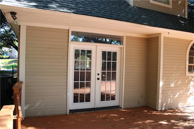 entrance to property featuring a wooden deck and french doors