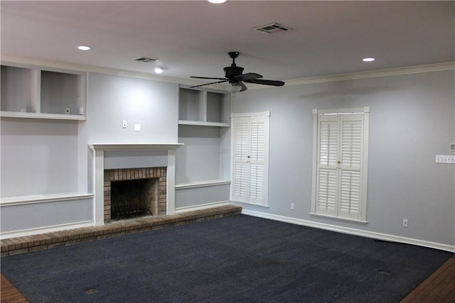 unfurnished living room with hardwood / wood-style floors, a brick fireplace, ceiling fan, and crown molding