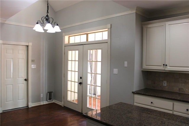 entryway with a chandelier, french doors, dark hardwood / wood-style flooring, and ornamental molding