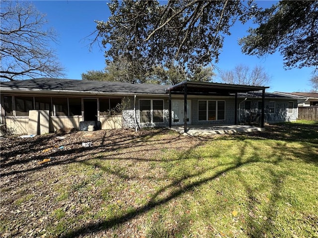 back of house featuring a patio area and a yard