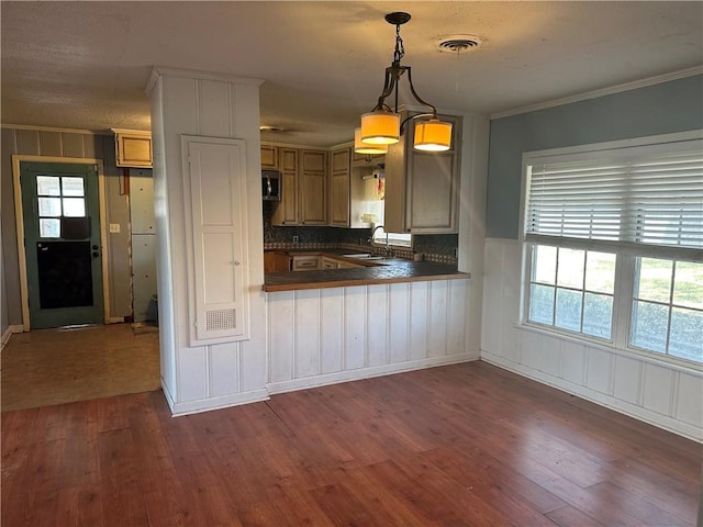 kitchen with dark countertops, stainless steel microwave, dark wood finished floors, and visible vents