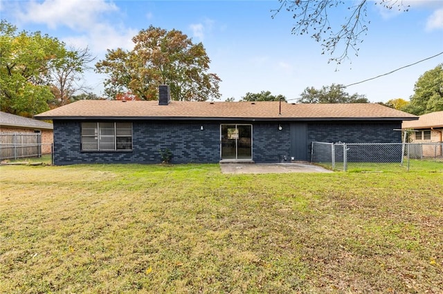 rear view of property with a patio area and a yard