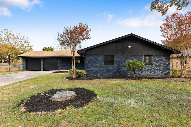 view of front of home featuring a garage and a front lawn