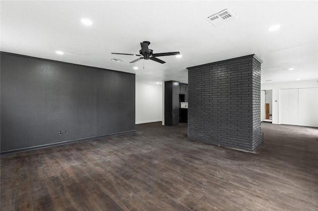 unfurnished living room featuring ceiling fan and dark wood-type flooring