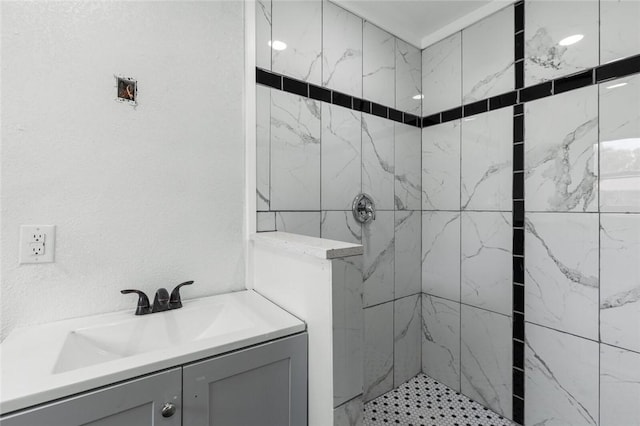 bathroom featuring vanity and tiled shower