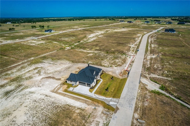 birds eye view of property with a rural view