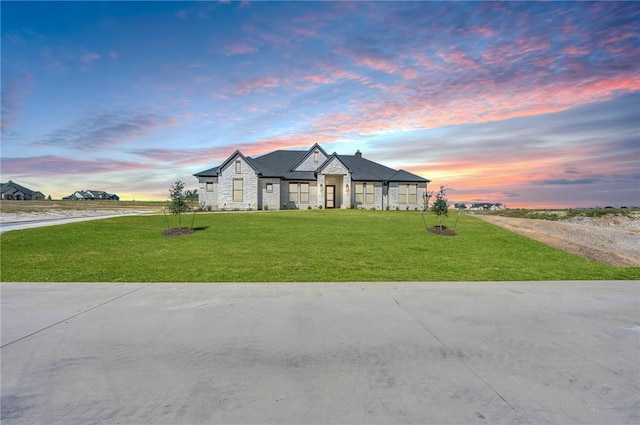 french provincial home with a lawn