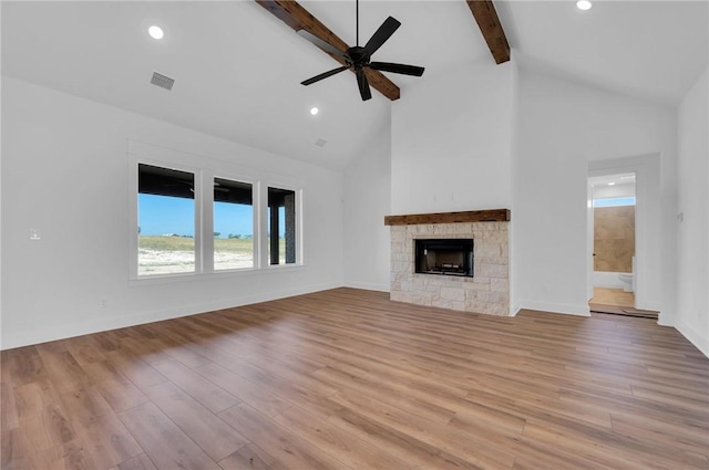 unfurnished living room with beam ceiling, ceiling fan, high vaulted ceiling, and light wood-type flooring