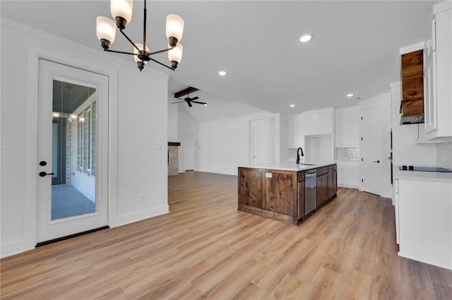 kitchen with dishwasher, white cabinetry, light wood-type flooring, and a kitchen island with sink