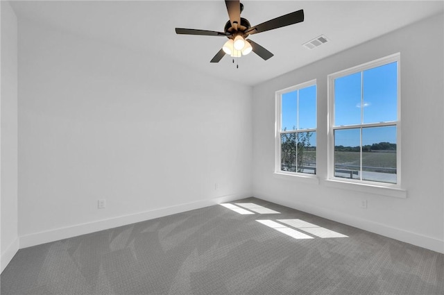 carpeted empty room featuring ceiling fan