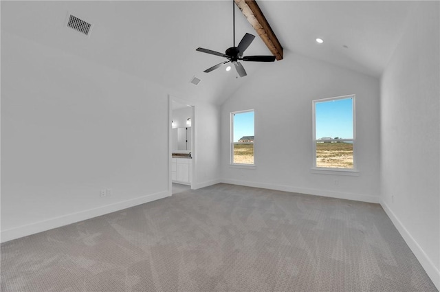 unfurnished living room featuring lofted ceiling with beams, ceiling fan, and light carpet