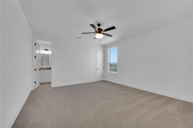 carpeted empty room featuring ceiling fan