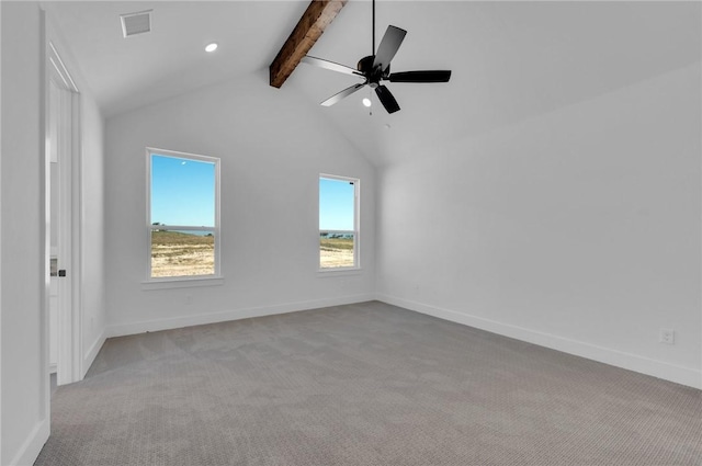 carpeted spare room featuring vaulted ceiling with beams and ceiling fan