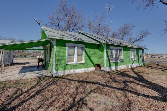 view of side of property featuring a carport