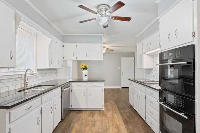 kitchen with sink, stainless steel appliances, decorative backsplash, white cabinets, and hardwood / wood-style flooring