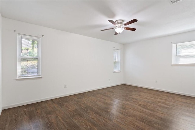 spare room featuring ceiling fan and dark wood-type flooring