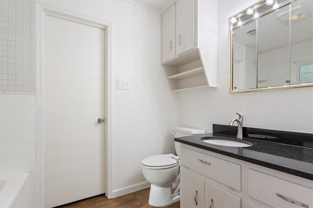 full bathroom with bathtub / shower combination, vanity, hardwood / wood-style flooring, and toilet