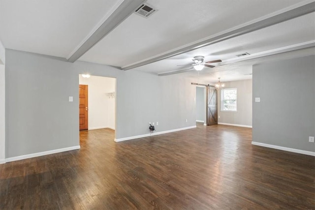 spare room featuring dark hardwood / wood-style floors, a barn door, beam ceiling, and ceiling fan