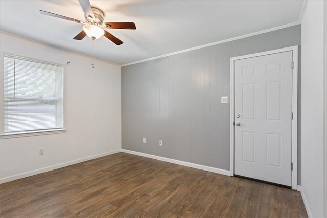 spare room with wood walls, dark hardwood / wood-style floors, ceiling fan, and crown molding