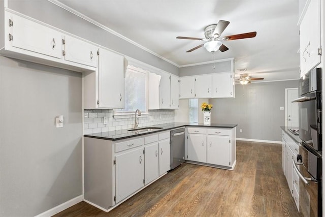 kitchen with stainless steel dishwasher, ornamental molding, sink, hardwood / wood-style flooring, and white cabinets