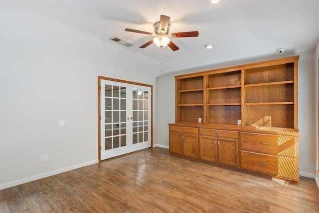 unfurnished living room featuring ceiling fan, french doors, and light hardwood / wood-style floors