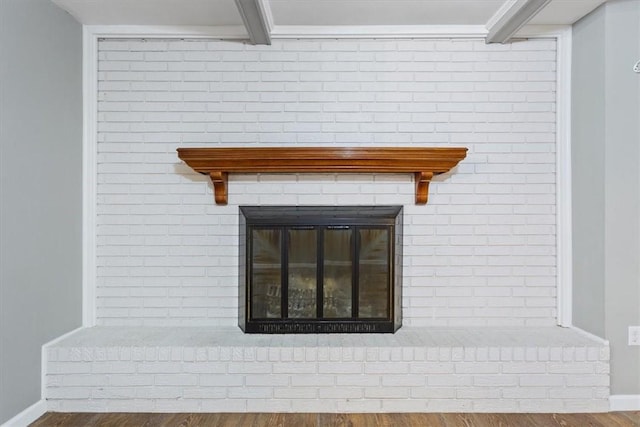 details with a fireplace, hardwood / wood-style floors, and beam ceiling