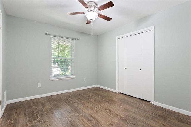 unfurnished bedroom featuring ceiling fan, dark hardwood / wood-style flooring, and a closet