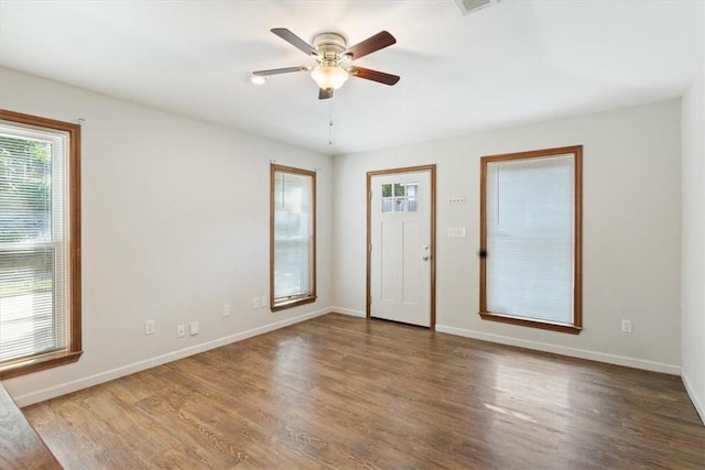 empty room with ceiling fan and hardwood / wood-style flooring