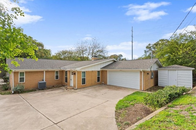 single story home featuring a storage unit, a garage, and central AC