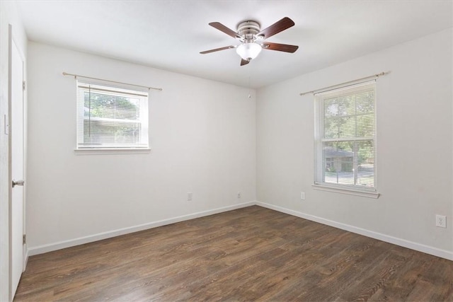 spare room with ceiling fan and dark wood-type flooring