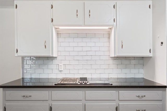 kitchen featuring white cabinets, tasteful backsplash, and stainless steel gas stovetop