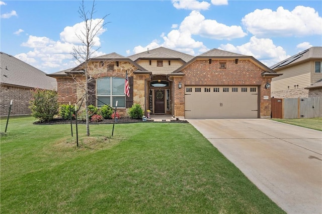 view of front of house with a garage and a front lawn