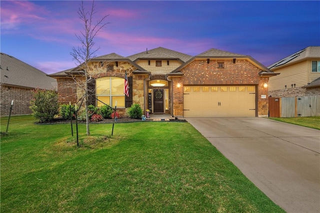 view of front of property with a lawn and a garage