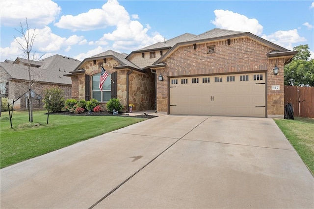 view of front of home with a garage and a front lawn