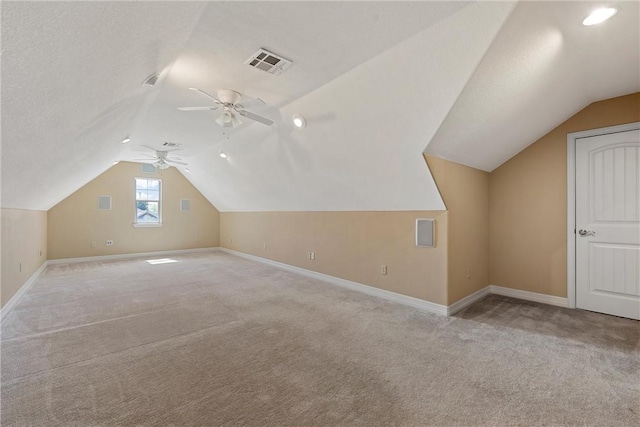 bonus room featuring ceiling fan, lofted ceiling, and light carpet