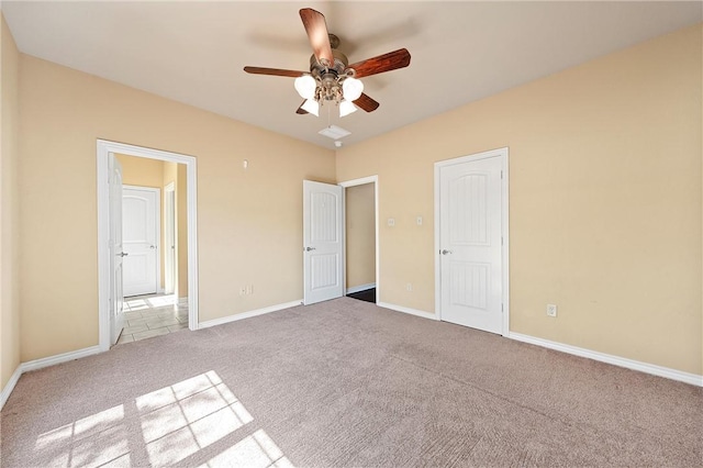 unfurnished bedroom featuring ceiling fan and light carpet