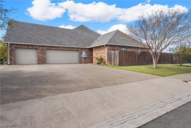 view of front of property featuring a garage and a front lawn